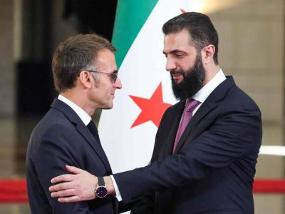 Syrian President Ahmed al-Sharaa (R) shakes hands with France's President Emmanuel Macron following a joint press conference in Damascus on July 7, 2026. French President Emmanuel Macron arrived in Damascus on July 6, 2026 for the first visit by a Western European head of state since Syria's new authorities took power in 2024, an AFP journalist said. Macron, who will depart on July 7, 2026, will advocate for "a free, pluralist Syria that respects each of its components" and plays a role in moderating Middle East tensions, the French presidency told journalists ahead of his arrival. (Photo by Ludovic MARIN / POOL / AFP)